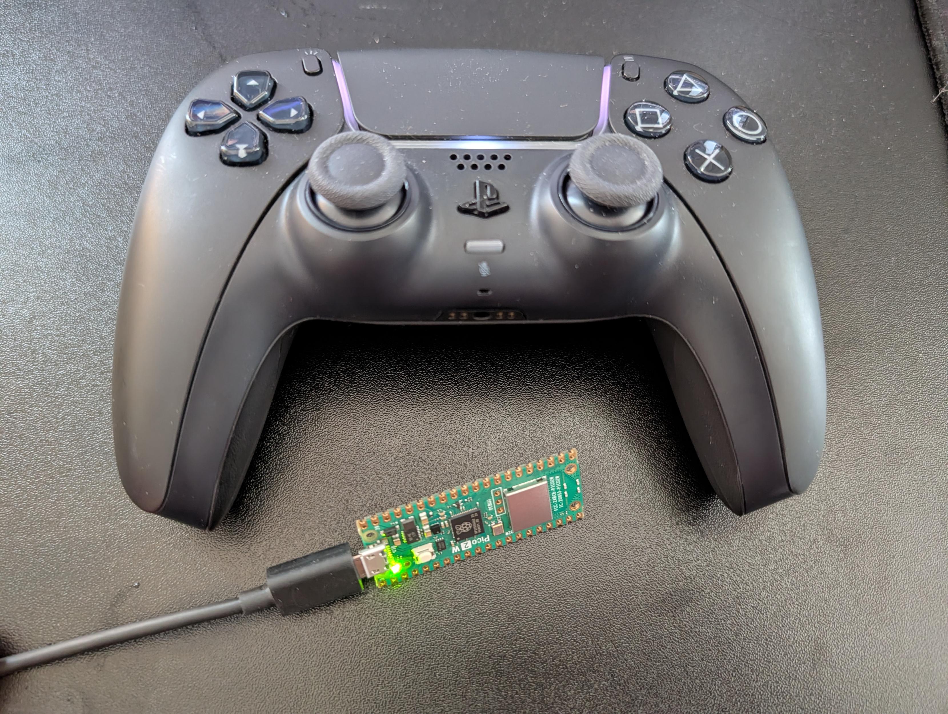 Black Dual Sense controller and a wired Raspberry PI Pico 2W.